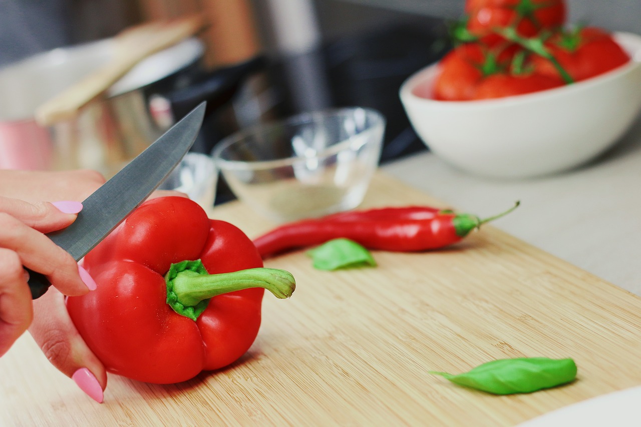 woman cutting a capsicum